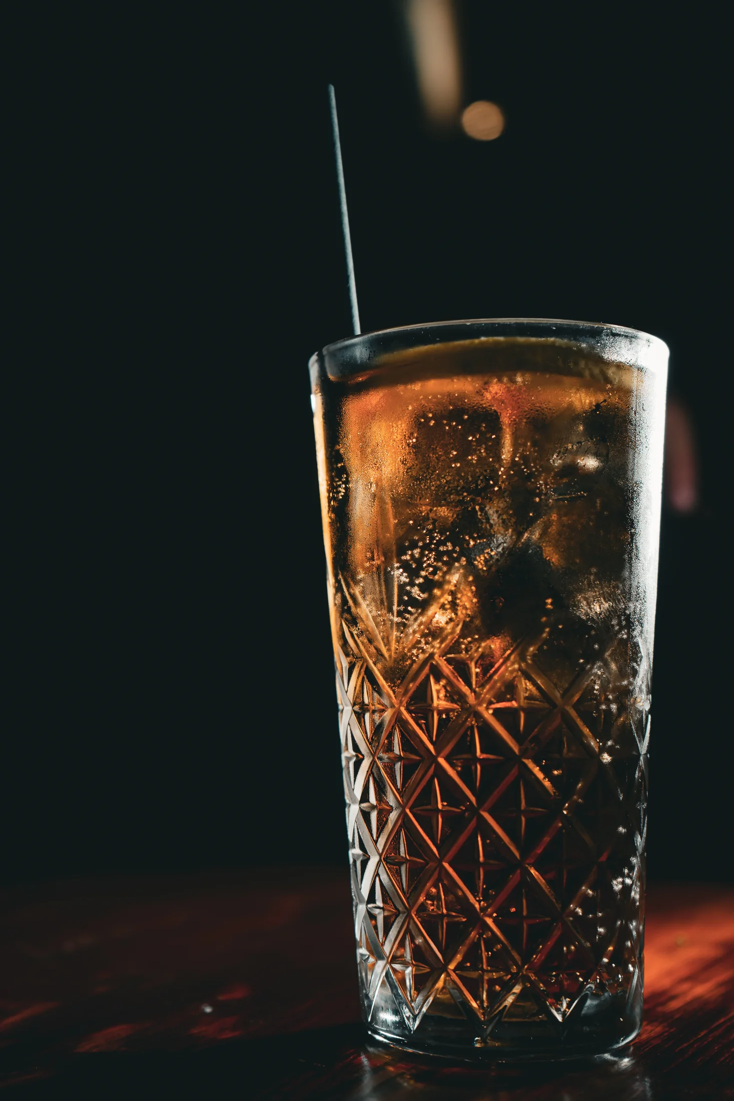 A tall dark cocktail served at Fox Bros Du
