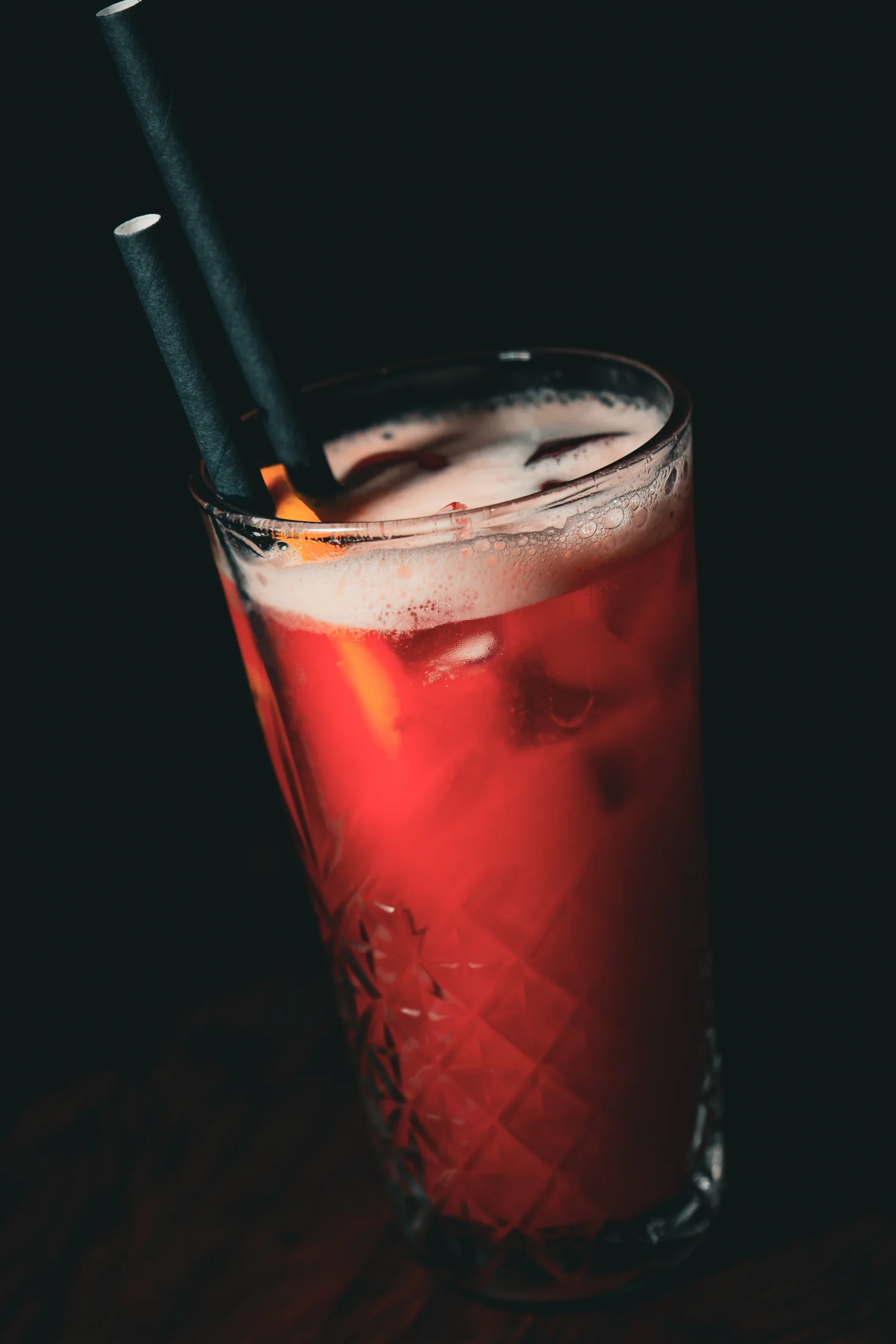 A bright red highball cocktail
